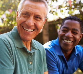 Two men smiling outdoors